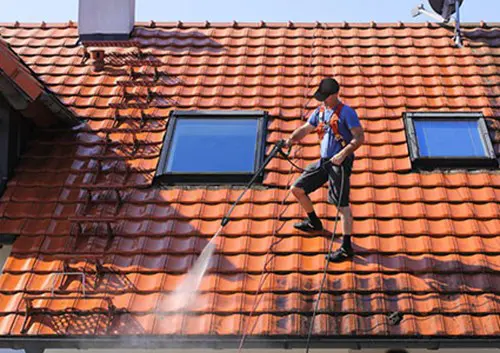 Man Soft Washing A Roof Resoration 1